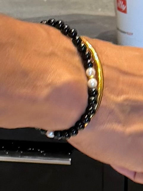 Close-up of The Luminary black pearl bracelet on the wrist