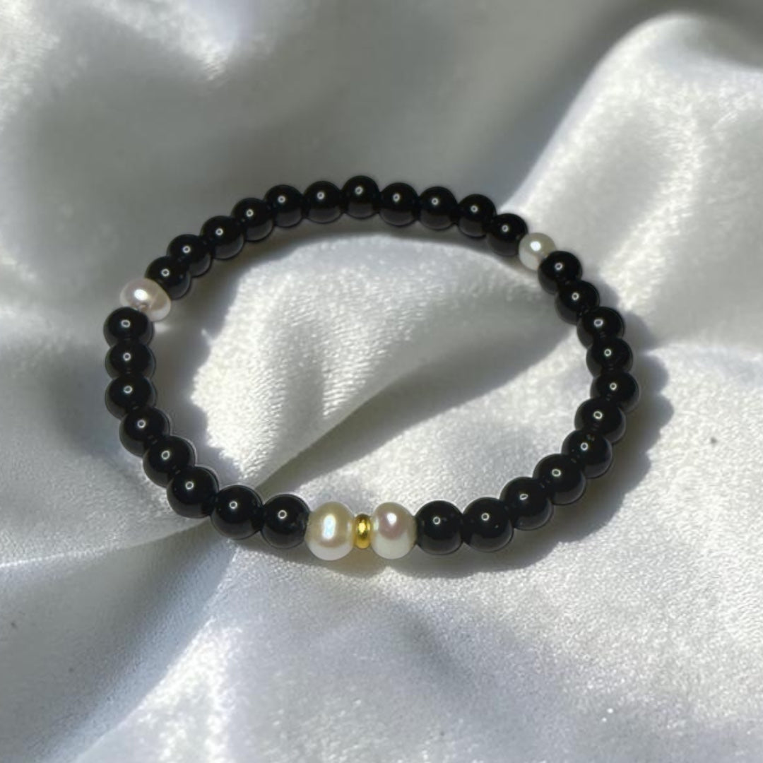 The Luminary black freshwater pearl bracelet flat lay