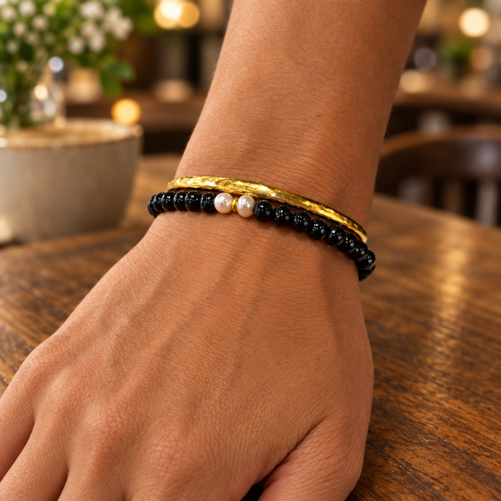 Black freshwater pearl bracelet styled with a square statement ring