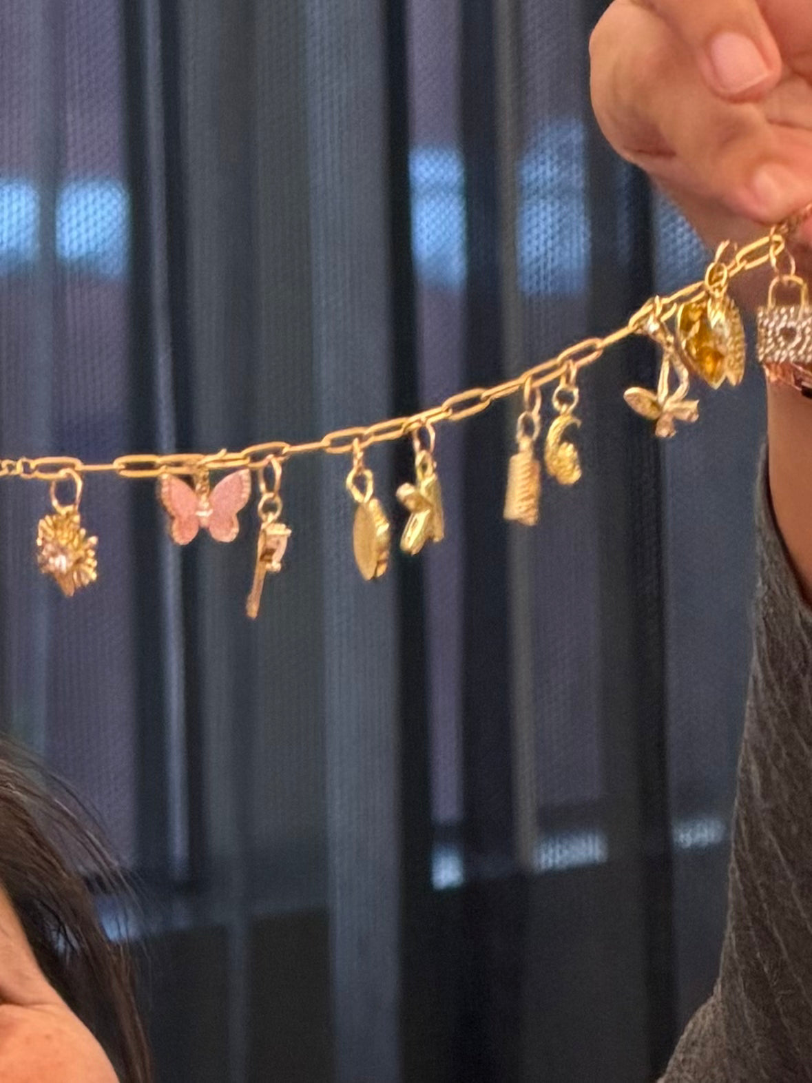 Close-up of a handmade custom gold charm bracelet